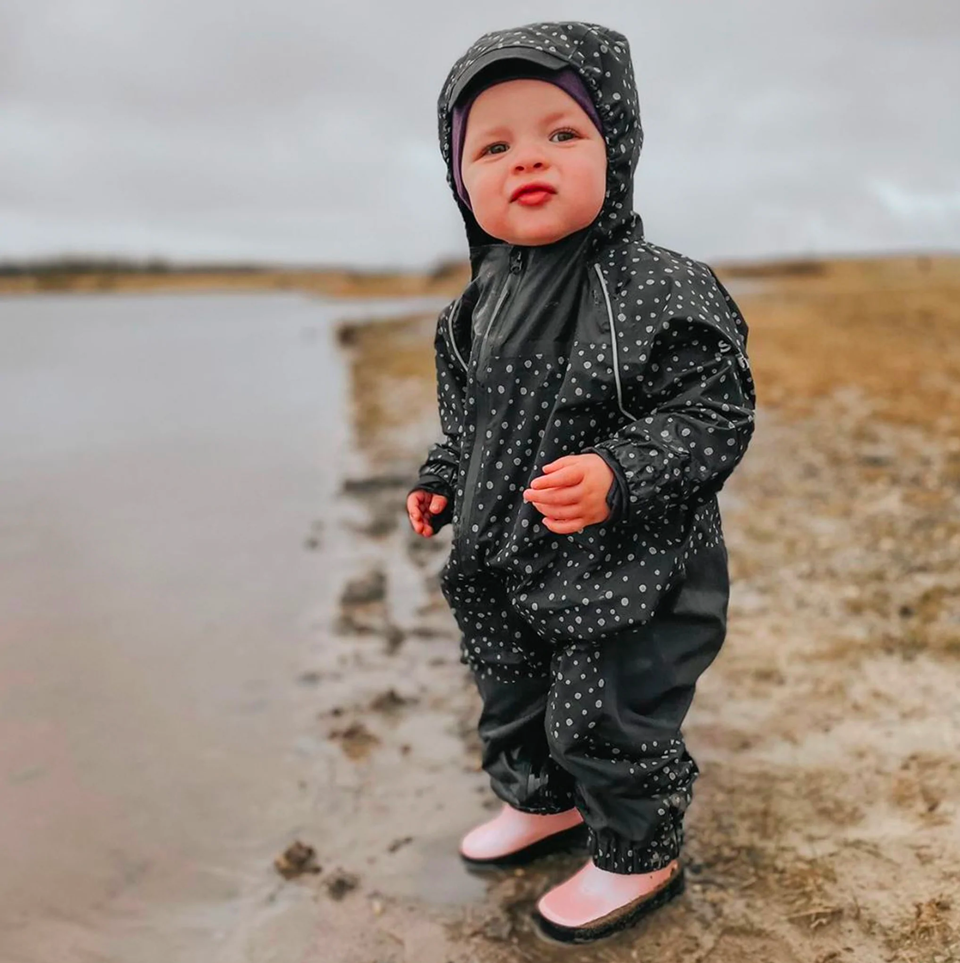 baby in a rain suit by Stonz