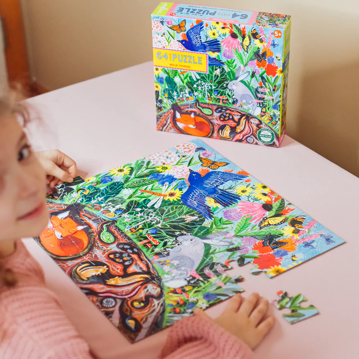 child building the Wild Things 64 piece puzzle at a table