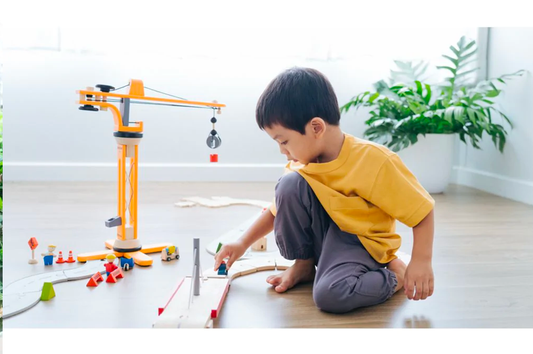 child Playing with plan toys Crane Set