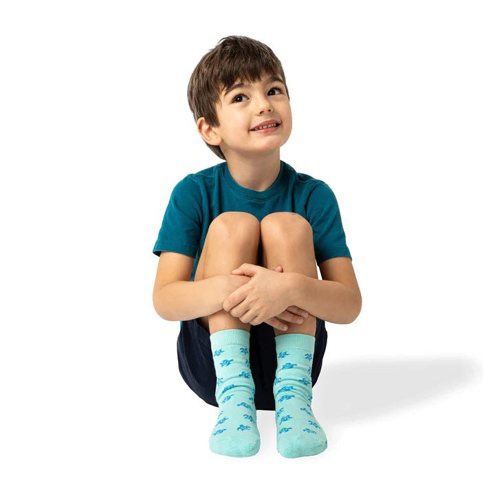 Child wearing a pair of socks from the socks that protect oceans set