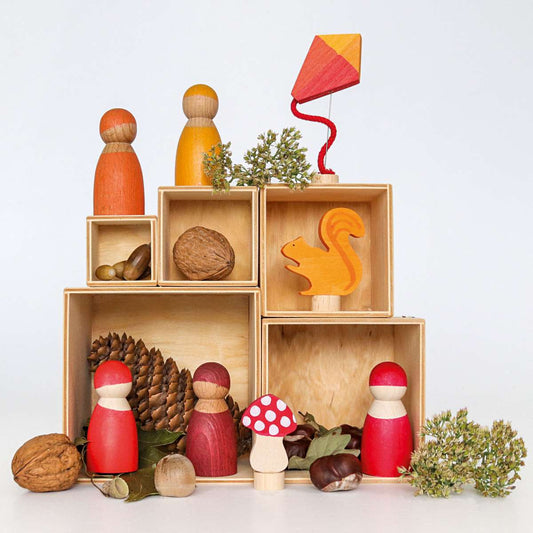 Scene with wooden people, mushroom, squirrel and kite wooden figures, and fall leafage and nature elements