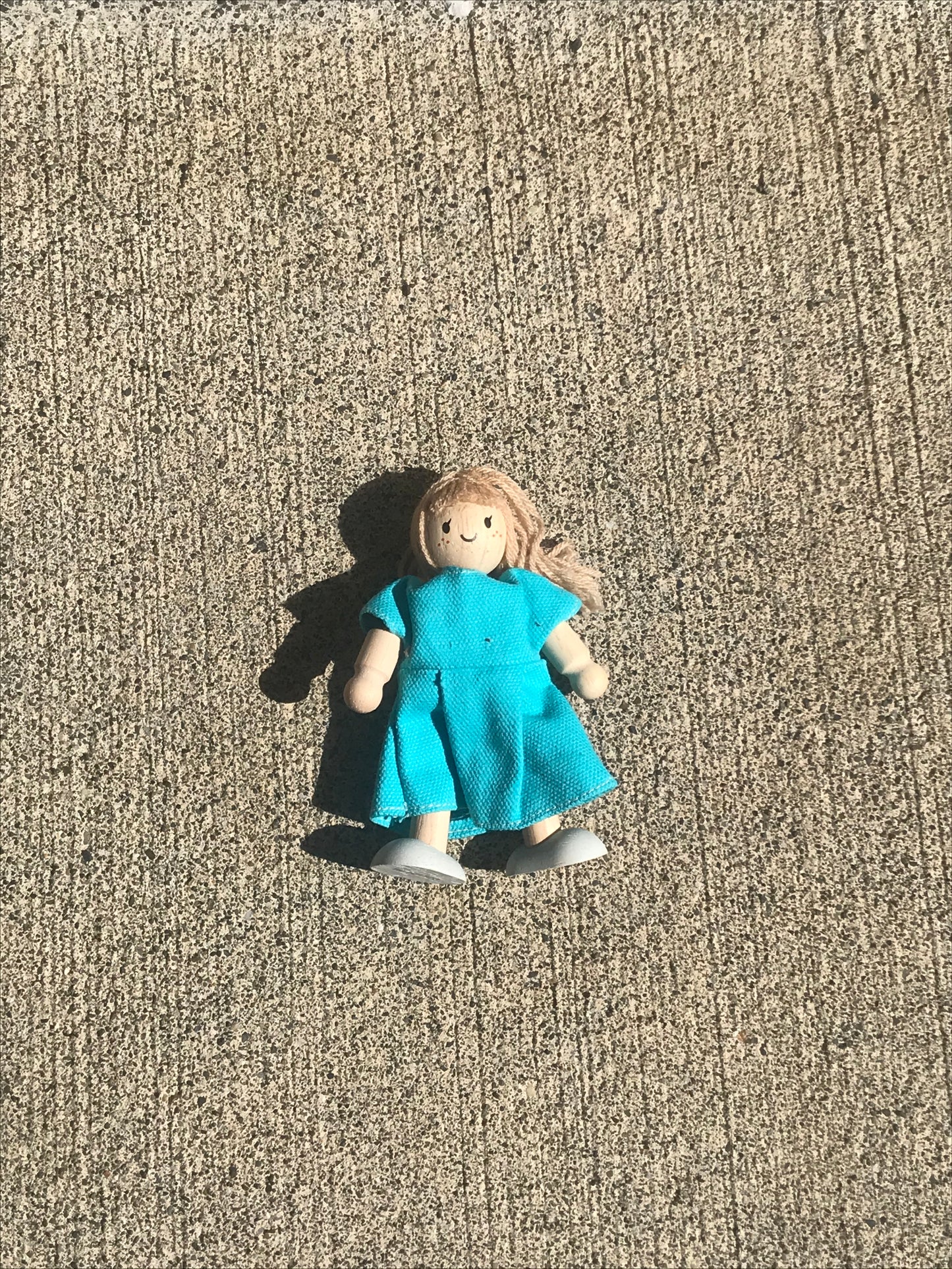 plan toys doll in a blue dress
