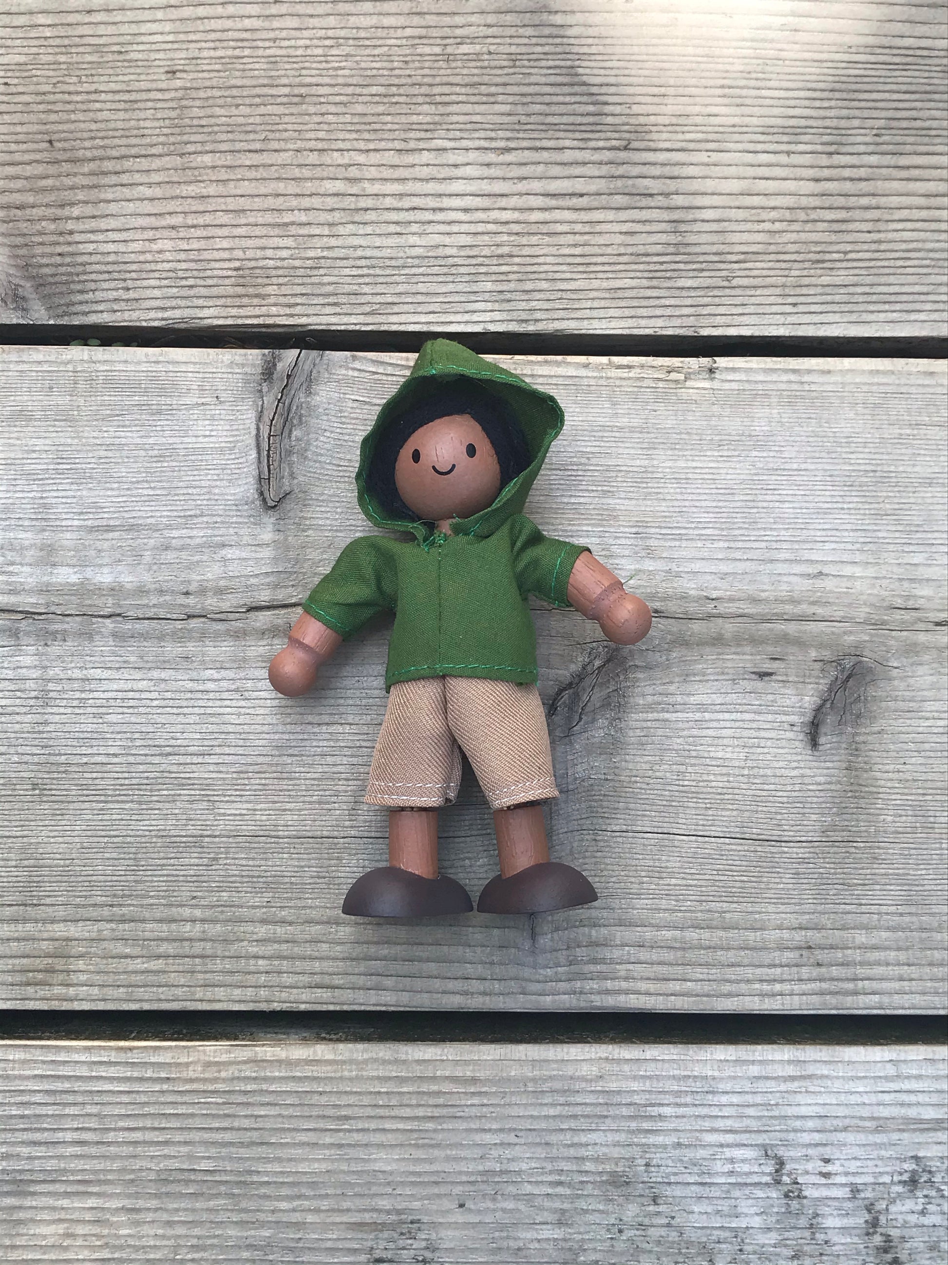 plan toys doll in a green Hoodie