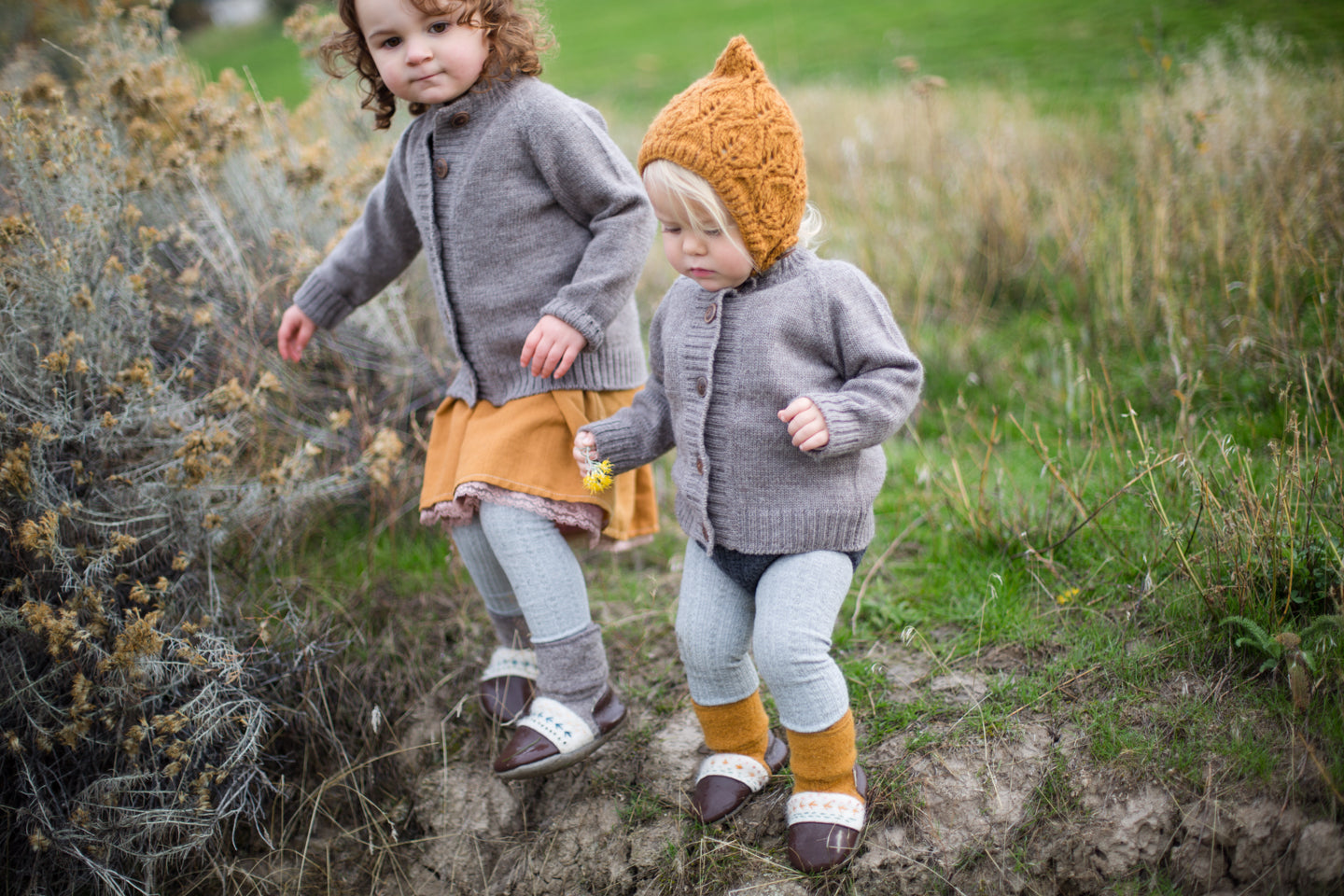 Kids playing outside wearing merino wool bonnets  and sweaters by Nook Design