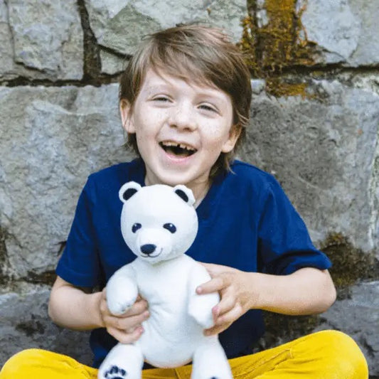 Child holding Klondike the Polar Bear