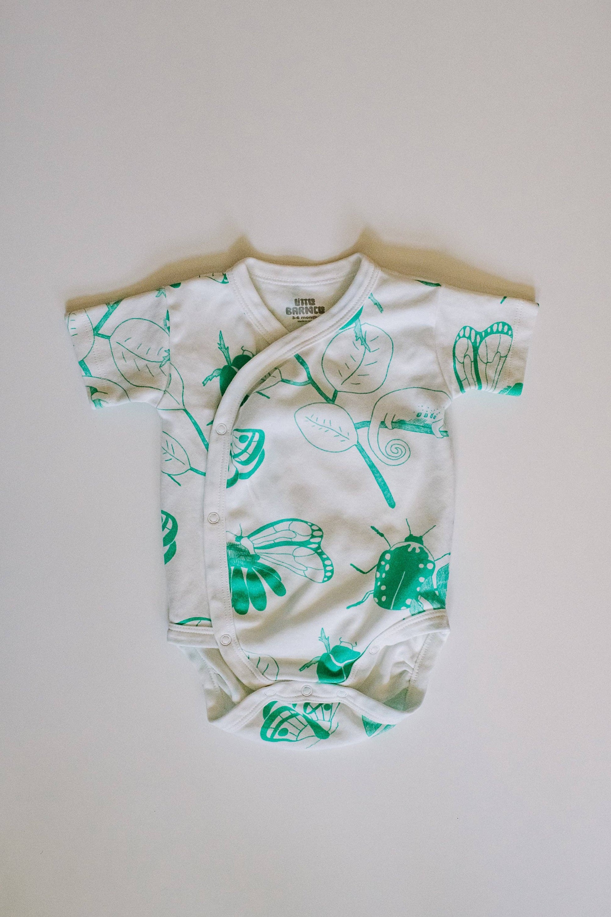 Bug baby bodysuit flat lay