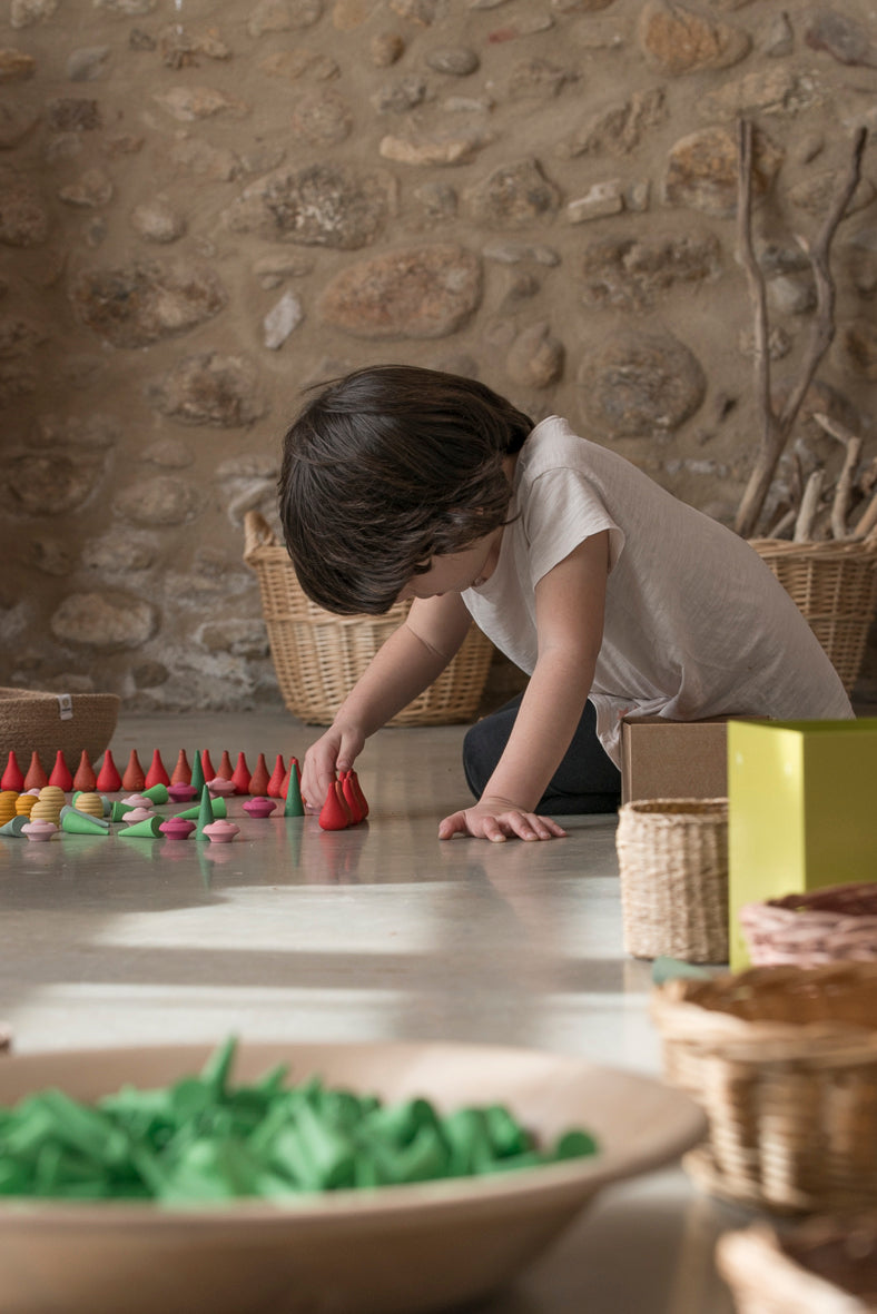 Child playing with fire and green cone mandalas