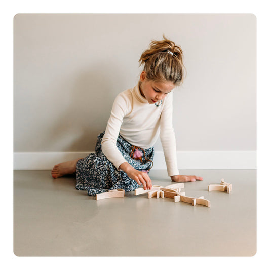Child playing with Abel Golden Ratio Mini Blocks on the floor