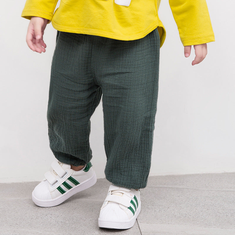 Kid wearing muslin pants by Mama Siesta in green