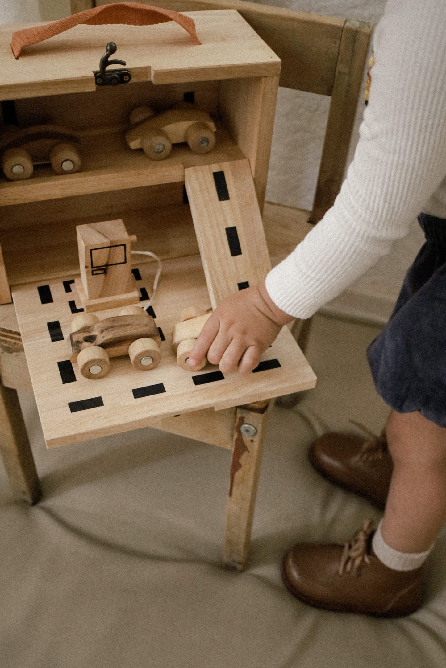 Child playing with Portable car park set