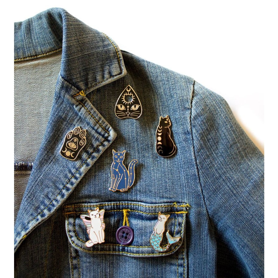 Enamel pins by Bee's Knees on a jean jacket