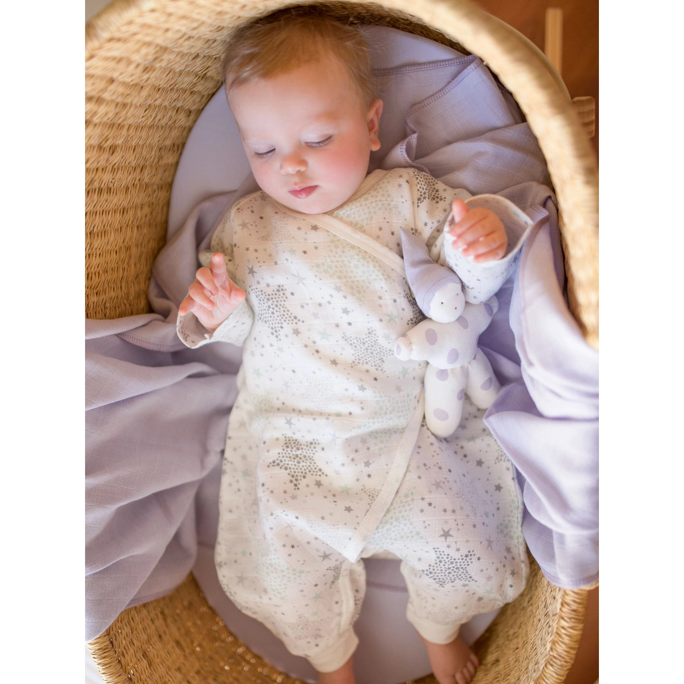 baby and doll laying in a basket wearing Muslin Side Snap Star Wrap Kimono by under the nile