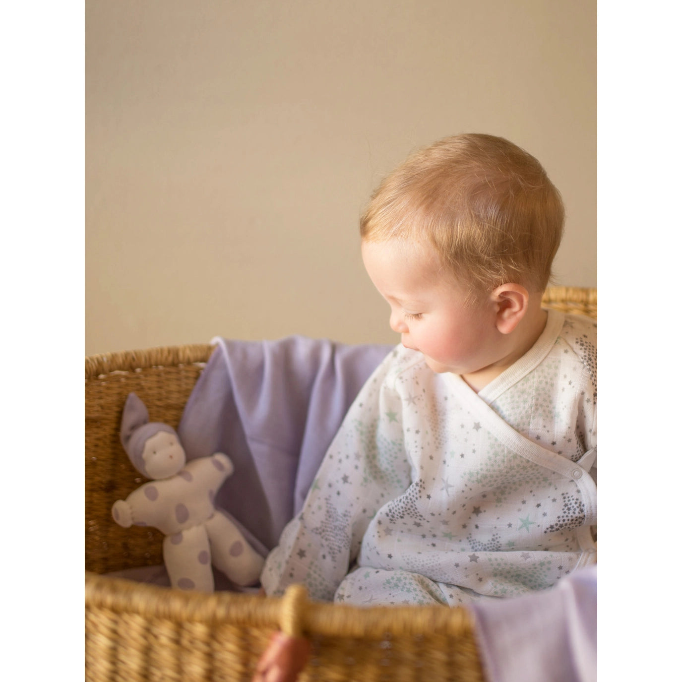 baby and doll sitting and wearing a Muslin Side Snap Star Wrap Kimono