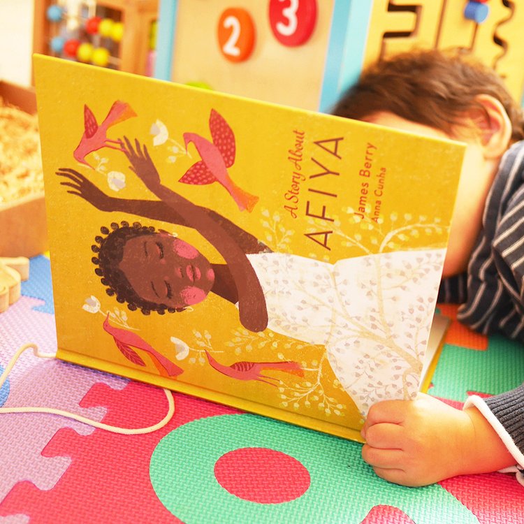 A child reading A Story About Afiya