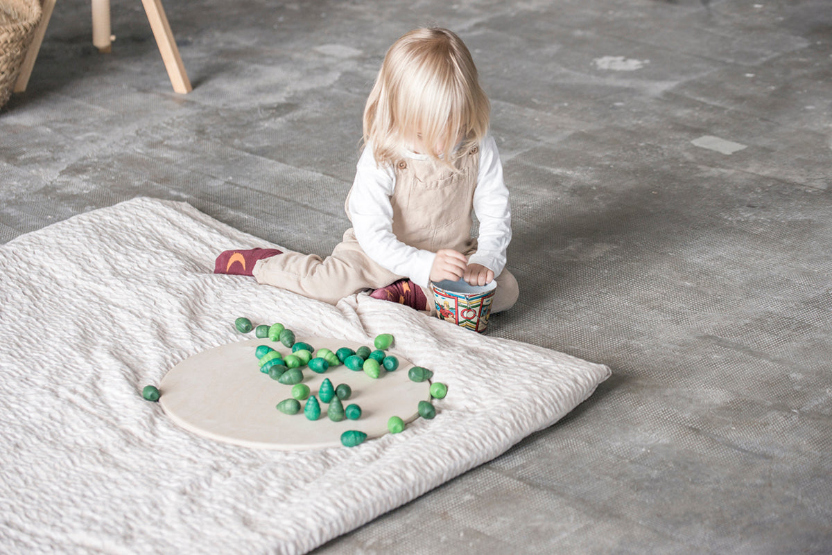 Child playing with tree mandala