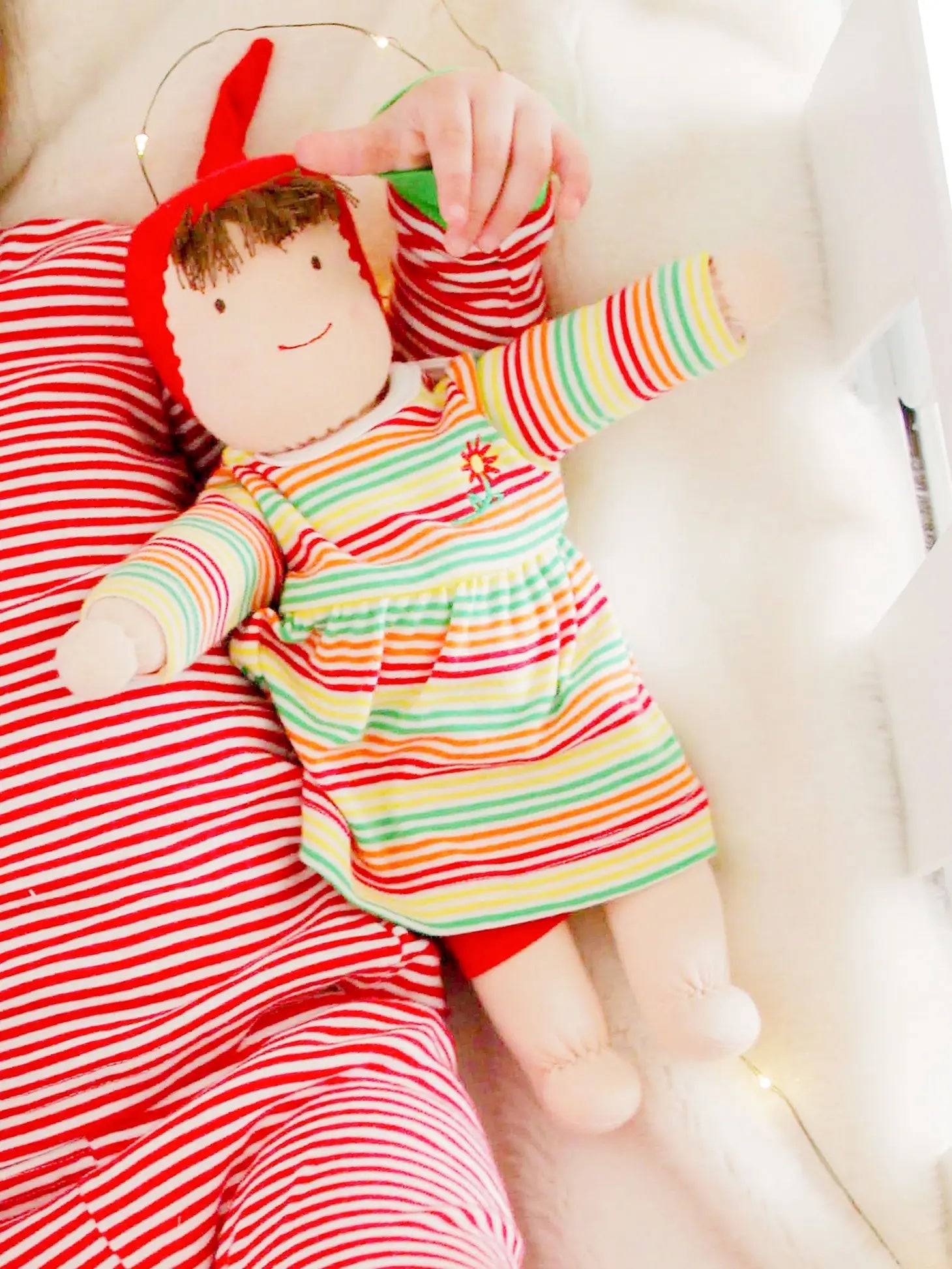 Baby holding Jill Waldorf doll