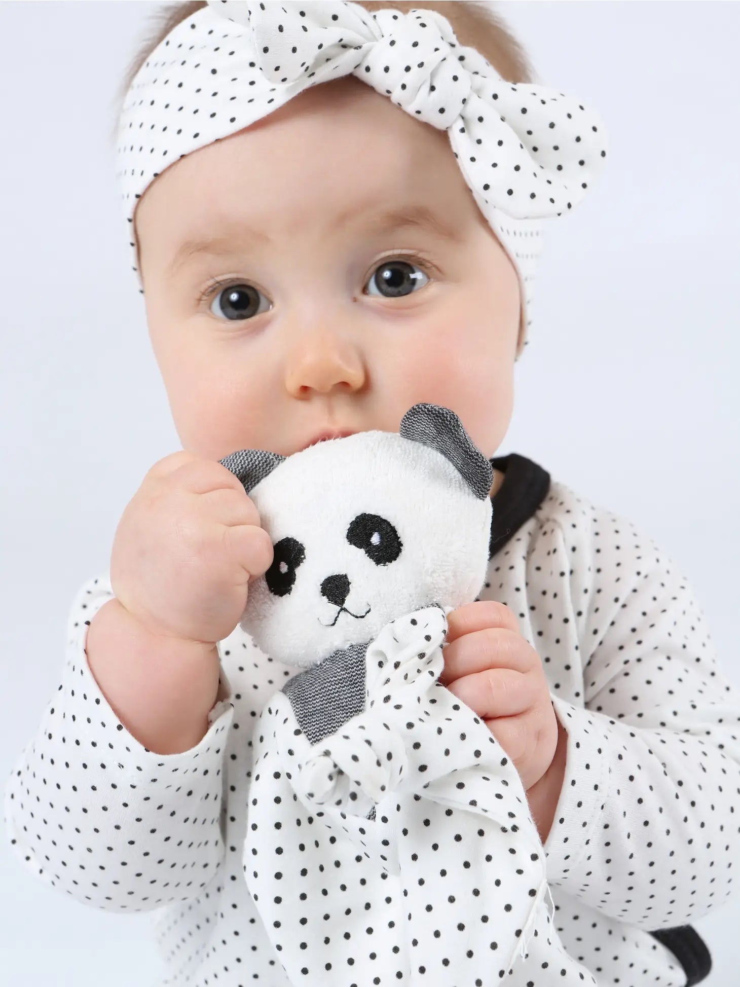 Baby holding organic panda lovey