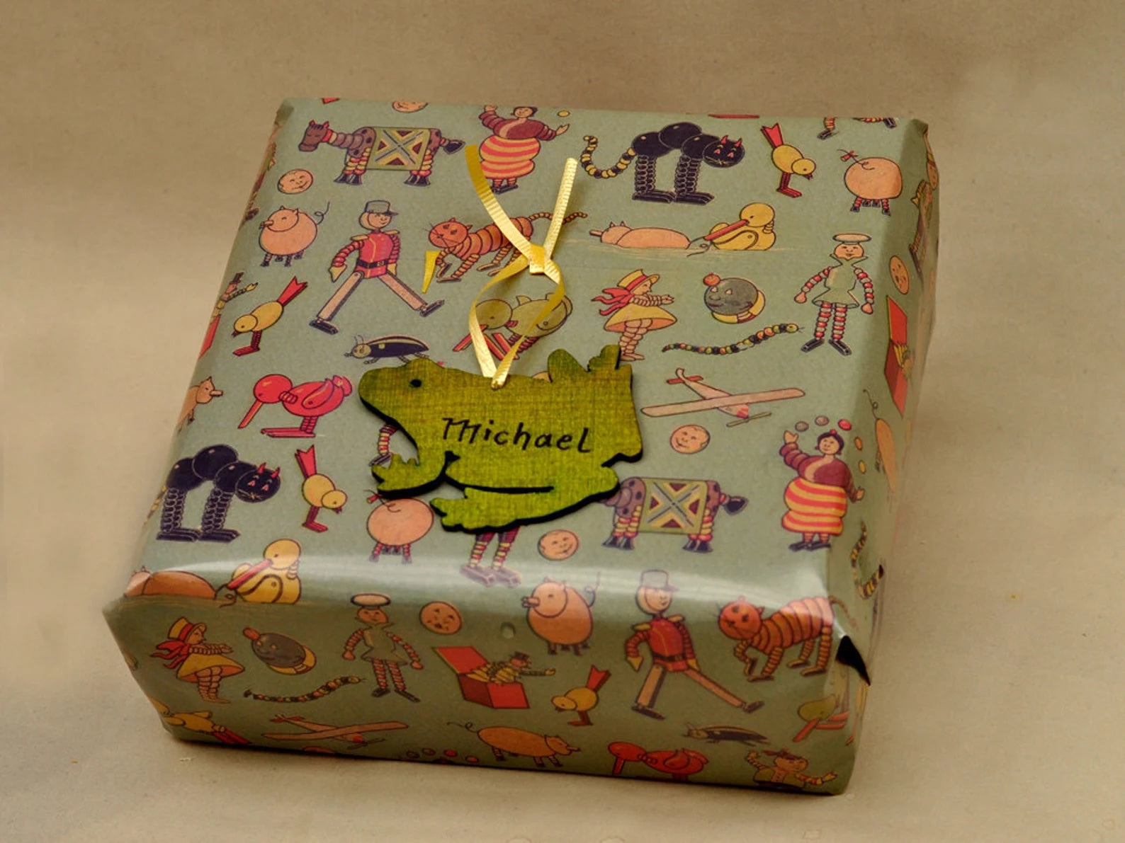 Frog wooden ornament used as gift tag on a present