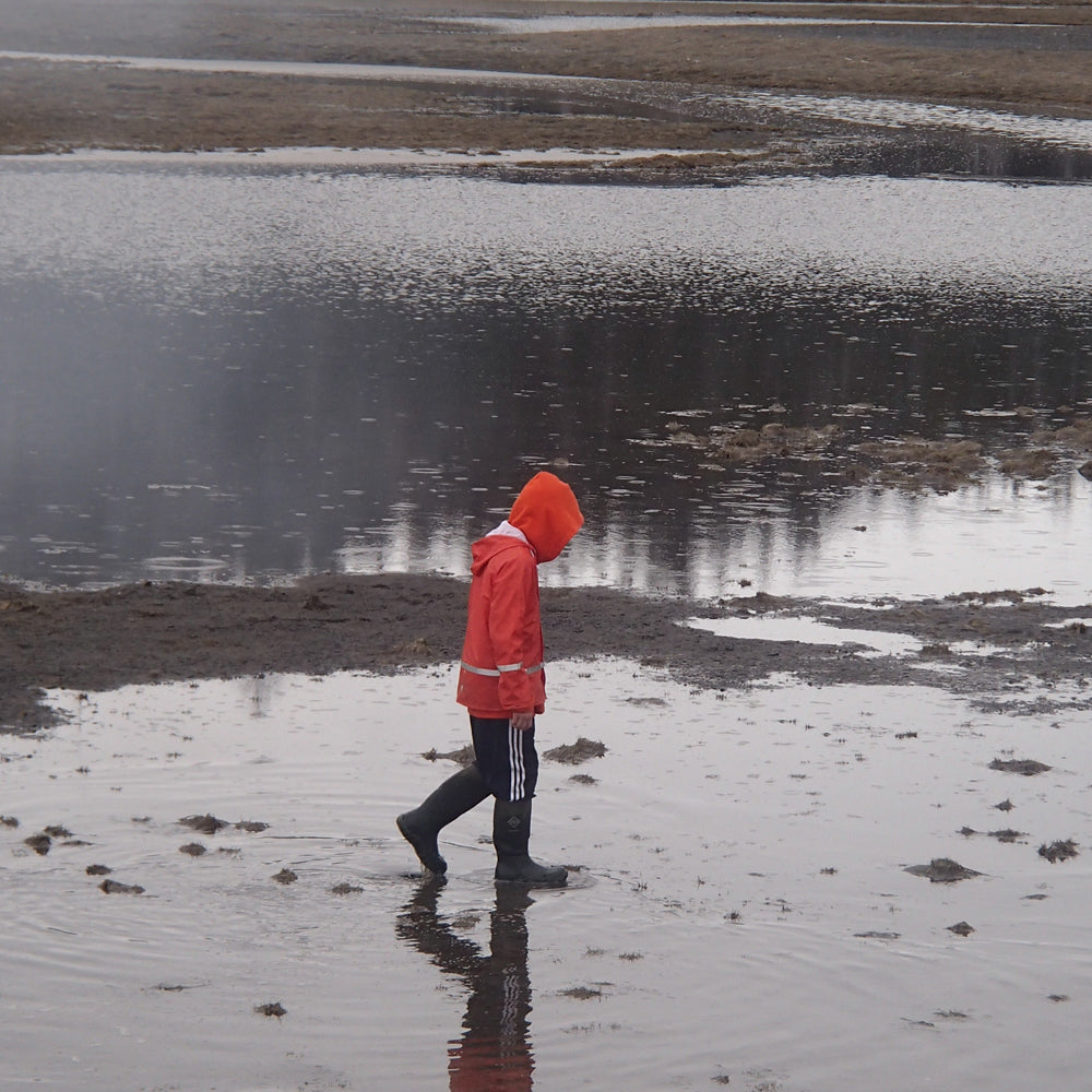 kid in a grundens rain jacket